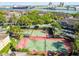 Aerial view of the community and tennis courts, nearby waterfront, and green landscaping at 628 Arbor Lake Ln, Tampa, FL 33602