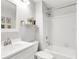 Bathroom boasts a shower-over-tub, toilet, sink and floral arrangement at 628 Arbor Lake Ln, Tampa, FL 33602