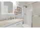 Modern bathroom with a marble countertop vanity, a framed print, and a sleek glass-enclosed shower at 628 Arbor Lake Ln, Tampa, FL 33602