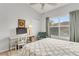 Bright bedroom features a comfy bed, desk, chair, and large window with natural light at 628 Arbor Lake Ln, Tampa, FL 33602