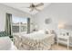Bright bedroom features a comfy bed, nightstands, lamps and large window with natural light at 628 Arbor Lake Ln, Tampa, FL 33602