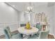 Bright dining room featuring a round table with blue upholstered chairs and a modern chandelier at 628 Arbor Lake Ln, Tampa, FL 33602