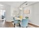 Charming dining area with stylish blue chairs, elegant chandelier, and decorative accents creates a warm atmosphere at 628 Arbor Lake Ln, Tampa, FL 33602