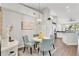 Elegant dining area featuring stylish seating, modern lighting, and seamless transition to a well-equipped kitchen at 628 Arbor Lake Ln, Tampa, FL 33602