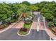 Gated community entrance featuring lush landscaping, brick accents, and a security booth at 628 Arbor Lake Ln, Tampa, FL 33602