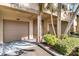 Condo exterior featuring garages, entry doors and landscaping at 628 Arbor Lake Ln, Tampa, FL 33602