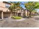 Exterior view of Island Place townhomes featuring garages and well-kept landscaping at 628 Arbor Lake Ln, Tampa, FL 33602
