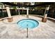 Community hot tub featuring a safety rail, stone pillars, and shade covering at 628 Arbor Lake Ln, Tampa, FL 33602