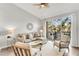 Inviting living room with comfortable seating, hardwood floors, and a view of the balcony at 628 Arbor Lake Ln, Tampa, FL 33602