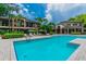 Beautiful community pool surrounded by lush landscaping and multiple-story residential buildings at 628 Arbor Lake Ln, Tampa, FL 33602