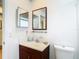 Bathroom with wood vanity and dark framed mirror at 6910 Lake Place Ct, Tampa, FL 33634