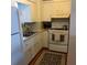 Kitchen with oven, sink, and wood flooring at 7000 Beach Plz # 604, St Pete Beach, FL 33706