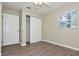 Bright bedroom featuring wood-look floors, closet, and window with blinds at 701 15Th S Ave, St Petersburg, FL 33701