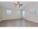Spacious bedroom with wood-look floors and natural light from multiple windows at 701 15Th S Ave, St Petersburg, FL 33701