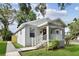 Stylish home featuring a covered front porch, fresh landscaping, and an inviting walkway at 701 15Th S Ave, St Petersburg, FL 33701