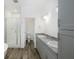 Bright and spacious bathroom with dual sinks, gray cabinets, a shower, and a separate tub at 7529 62Nd N Way, Pinellas Park, FL 33781