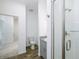 Bright bathroom featuring a tile shower, gray vanity with granite countertop, toilet, and wood-look flooring at 7529 62Nd N Way, Pinellas Park, FL 33781