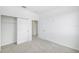 Comfortable bedroom with carpet flooring, a closet with sliding doors, and a hall entrance at 7529 62Nd N Way, Pinellas Park, FL 33781