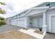 Townhouse exterior showing a one-car garage and a welcoming front entrance with a small plant at 7529 62Nd N Way, Pinellas Park, FL 33781