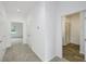 Hallway with doors to bedrooms and a bathroom featuring a glass-enclosed shower stall at 7529 62Nd N Way, Pinellas Park, FL 33781