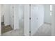 Bright hallway with neutral carpet and white doors leading to bedrooms and a tiled bathroom at 7529 62Nd N Way, Pinellas Park, FL 33781