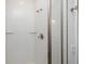 White tile shower featuring glass doors and glass shelving at 7529 62Nd N Way, Pinellas Park, FL 33781