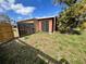Backyard shed with wood fence, foliage, and a mature tree for privacy at 7563 Meadowlawn N Dr, St Petersburg, FL 33702