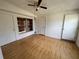Bedroom with hardwood floors, two closets, and a ceiling fan at 7563 Meadowlawn N Dr, St Petersburg, FL 33702