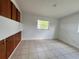 Bedroom with tiled floors, bright lighting, and built-in closet storage at 7563 Meadowlawn N Dr, St Petersburg, FL 33702