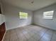 Empty bedroom with tiled floors and natural light through windows at 7563 Meadowlawn N Dr, St Petersburg, FL 33702
