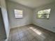 Bedroom with tiled flooring and natural light from two windows at 7563 Meadowlawn N Dr, St Petersburg, FL 33702