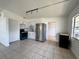Eat-in kitchen featuring modern appliances and white cabinetry at 7563 Meadowlawn N Dr, St Petersburg, FL 33702