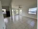 Living room with tile floors, and natural light streaming in from the door and windows at 7563 Meadowlawn N Dr, St Petersburg, FL 33702