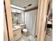 Well-lit bathroom featuring a vanity, toilet, shower and decor pieces, offering a clean space at 7623 Radcliffe Cir # 211A, Port Richey, FL 34668