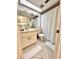 Bright bathroom featuring a sink, toilet, and shower with white shower curtain at 7623 Radcliffe Cir # 211A, Port Richey, FL 34668