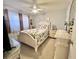 Cozy bedroom with a ceiling fan, two windows and a beautifully dressed bed and dresser at 7623 Radcliffe Cir # 211A, Port Richey, FL 34668