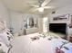 Bright bedroom featuring a ceiling fan, mirrored dresser and a comfortably adorned bed at 7623 Radcliffe Cir # 211A, Port Richey, FL 34668