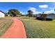 A charming community featuring a red walking path, gazebo, and lush green grass at 7623 Radcliffe Cir # 211A, Port Richey, FL 34668