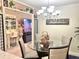 Inviting dining room flowing into a bar area, complete with a glass table and stylish decor at 7623 Radcliffe Cir # 211A, Port Richey, FL 34668