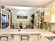 Open dining area with a glass table, chandelier, and seamless flow from the kitchen at 7623 Radcliffe Cir # 211A, Port Richey, FL 34668