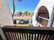 View from a balcony overlooking the carport parking area with lush landscaping in a desirable community at 7623 Radcliffe Cir # 211A, Port Richey, FL 34668