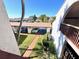 Balcony view showing carport, manicured landscaping, and building in a well-maintained neighborhood at 7623 Radcliffe Cir # 211A, Port Richey, FL 34668