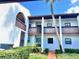 Charming condo featuring balconies, a well-maintained lawn, and classic architectural details at 7623 Radcliffe Cir # 211A, Port Richey, FL 34668