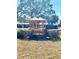 Wooden gazebo in the community with manicured hedges and mature trees in the background at 7623 Radcliffe Cir # 211A, Port Richey, FL 34668