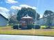 Community gazebo surrounded by manicured hedges and lawn, providing a tranquil outdoor space at 7623 Radcliffe Cir # 211A, Port Richey, FL 34668