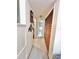 A hallway with a closet featuring louvered doors, connecting to other rooms in the home at 7623 Radcliffe Cir # 211A, Port Richey, FL 34668