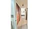 Hallway featuring a closet and leading to a bedroom with a comfortable bed and white furniture at 7623 Radcliffe Cir # 211A, Port Richey, FL 34668