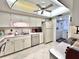 Bright kitchen with white cabinetry, stainless steel appliances, and a view into the laundry room at 7623 Radcliffe Cir # 211A, Port Richey, FL 34668