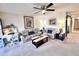 Inviting living room featuring neutral tones, comfortable seating, and a ceiling fan for added comfort at 7623 Radcliffe Cir # 211A, Port Richey, FL 34668