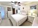 Inviting main bedroom featuring a comfortable bed, soft lighting, and classic white furniture at 7623 Radcliffe Cir # 211A, Port Richey, FL 34668